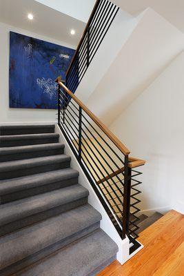 Stairway rebuilt, blackened-and-waxed railing fabrication with oak caps, carpet install.