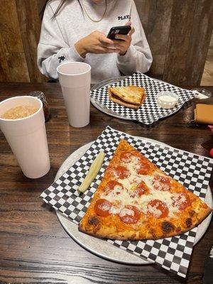 One slice of pepperoni pizza and soda