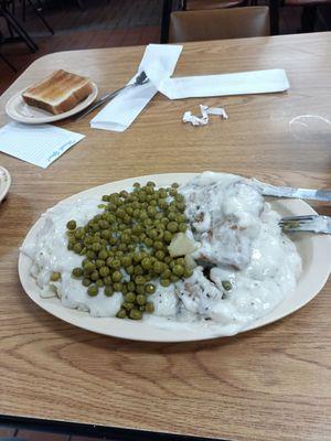 Double country fried steak, mashed potatoes and peas with Texas toast.