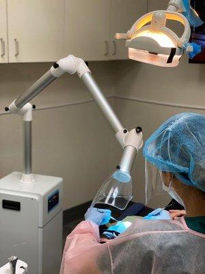 Extra oral suction unit used to reduce aerosol generated from dental procedures