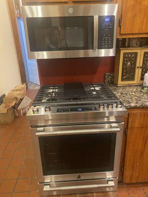 Jenn air dual fuel range and simple full sized microwave.