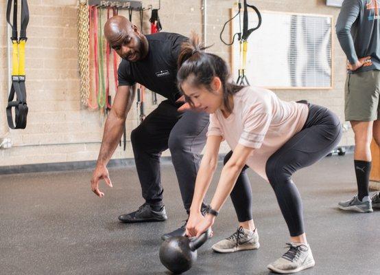 Coach Jimmy working with one of our athletes on Kettlebell Swings