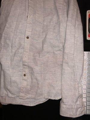 Bad lighting I know, but Gray shirt that has red stains throughout, most noticeable are bottom right & right sleeve.