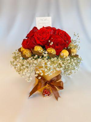 Cylinder Red rose arrangement with Premium hazelnut chocolates