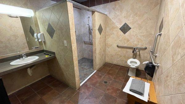 Very large and nice looking showers and toilet room