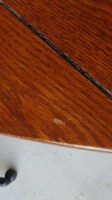 Damage to top of dining room table caused by DisasterLink / Pelican...the scuff mark - not the crack