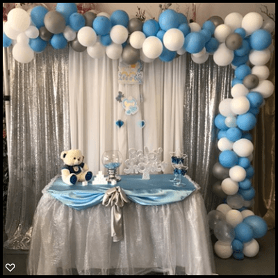 Organic Balloon Arch with backdrop and decorated table. Contact us for a quote