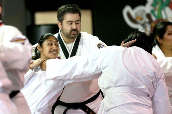 Mr. Mauro guiding a student through a defence drill.