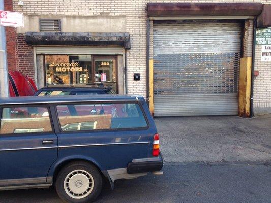 Shop facade, with the office on the left and the entrance to the garage on the right. (Gate down, temperature in the teens!)