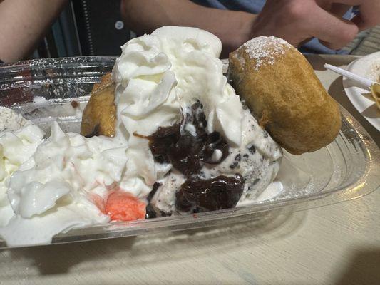 Fried Oreo sundae--three fried Oreos, cookies and cream ice cream, hot fudge, the pink is from the cherry :)