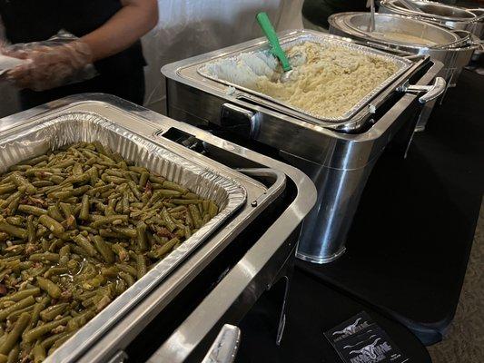 Buffet set up with green beans and mashed potatoes