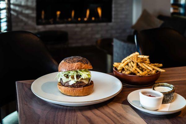 Flint's burger is sure to fan flames of desire with freshly ground chuck, smoked bacon jam, and gooey white cheddar on a poppy seed bun.