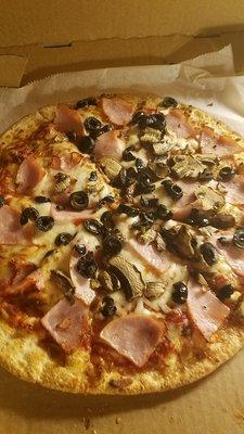 Delicious Canadian Bacon, mushrooms, black olives on thin crust. You can also order well done which is good and crunchy