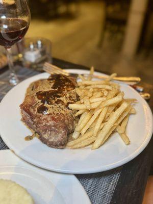 Steak Frites - seared New York strip steak with a classic cream, cognac and peppercorn sauce