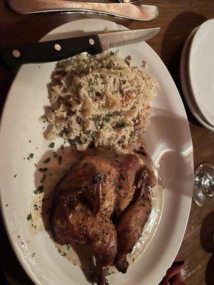 Cornish game hen cooked on a brick providing some crispy parts but still very juicy and flavorful.