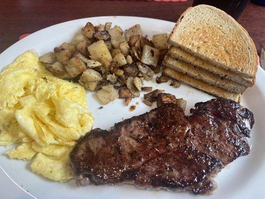 6 oz steak and eggs with nice and lightly buttered rye toast and home fries.