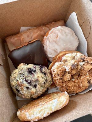 Maple Long John (top), Raspberry Bismarck, Cookie Dough Crunch, Triple Berry Danish, Lemon Blueberry Scone, and Chocolate Buttercream Square