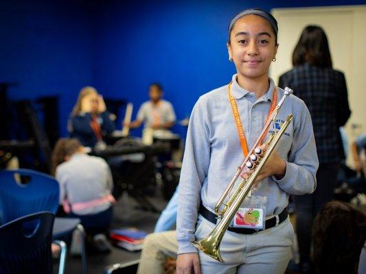 Great Oaks Charter Middle School Student Holding a Trumpet in Class