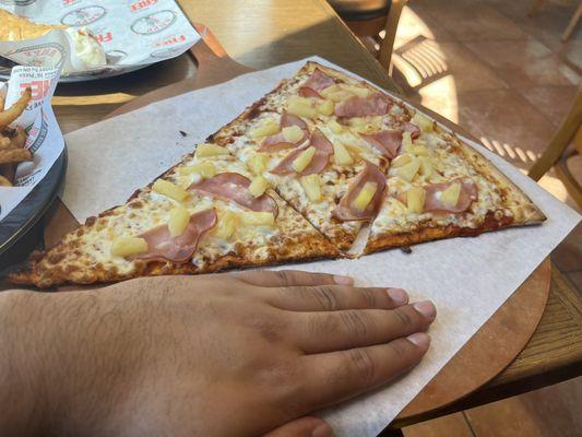 Pizza slice, in comparison with my hand!