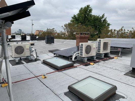 Roof installation of mini split units.