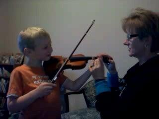 Helping my Grandson play the violin is fun!