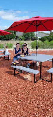 Two young ladies enjoining a wonderful day at the Alamo Ranch Food Truck Park.