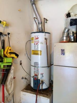 Before. 50 gal. water heater leaking and not up to code. The vent, earthquake strap not up to code.