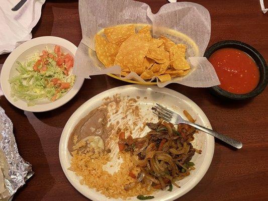 Fajitas, rice, beans, chips, salsa