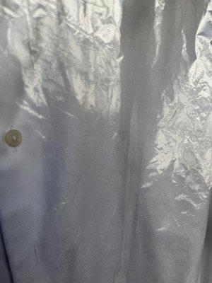 White shirt in bagged with lint.