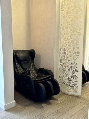 Massage chairs in waiting area, kept semi private with curtain dividers