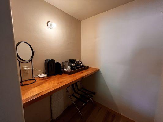 Closet area with coffee counter. There is a fridge but no microwave wave in the room.