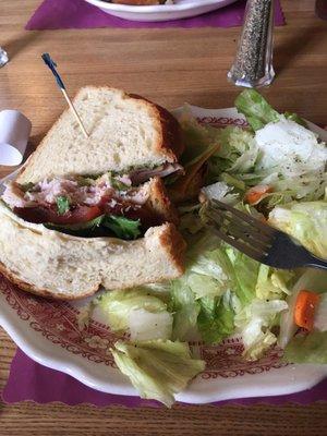 The Brass Plum classic sandwich on sour dough with a side salad.