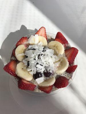 Unlimited bowl with acai, chia pudding, pumpkin flaxseed granola, strawberries, banana, blueberries, and coconut flakes.