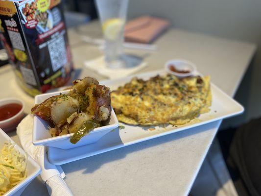 Meat lovers omelette with potatoes and grits and crunch French toast