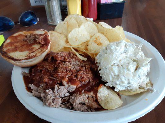 Chopped beef sandwich, potatp salad, and chips