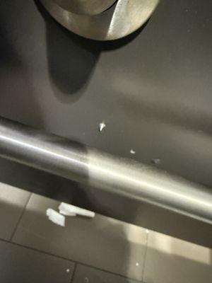 Screw poking out of the bathroom stall wall