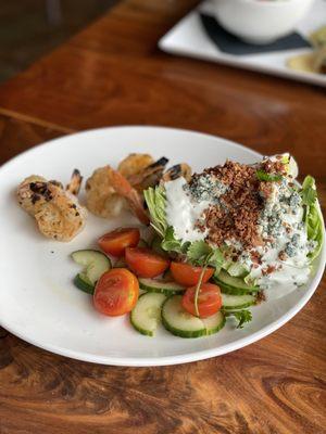 Blue cheese wedge salad with grilled shrimp. Very tasty.