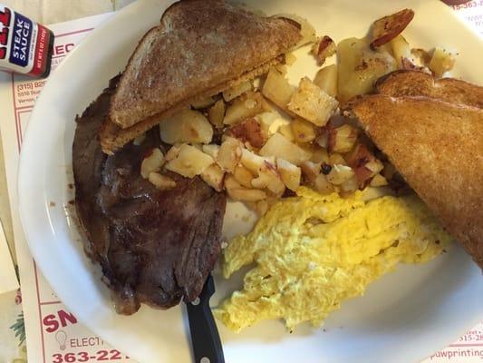 Breakfast special: prime ribs, eggs, toast, shredded hash.