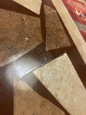 Broken table, tiles literally lifting out