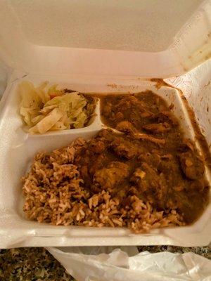 Curry chicken with rice and peas and cabbage.