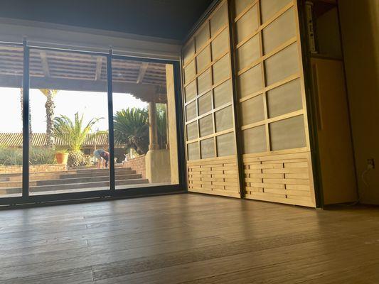 Our space is lined with windows allowing for lovely light in the space and a view of the courtyard.