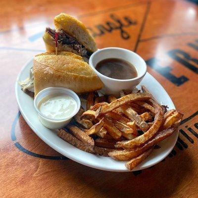 French Dip - Sliced roast beef and Swiss cheese on a baguette. Served with au jus