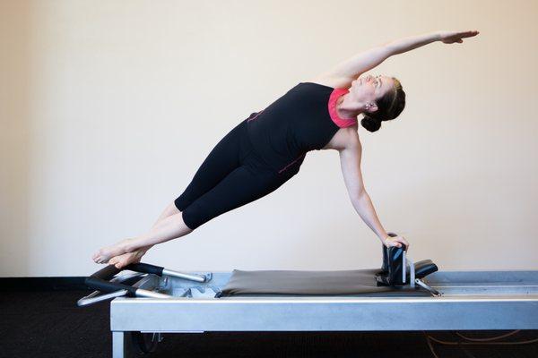 Martt Lawrence, Pilates Teacher-Trainer doing the Twist on the reformer