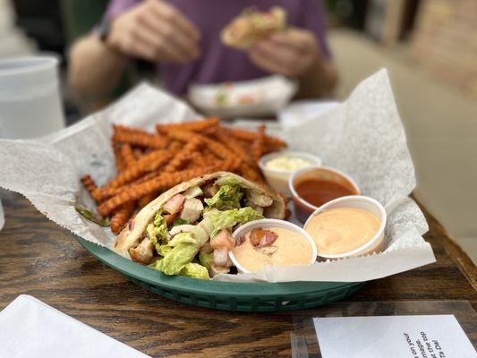 Pita wrap with sweet potato fries, mayonnaise, chipotle ranch, and a house made hot sauce.