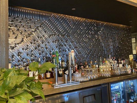 The wall behind the bar - it's all cutlery!