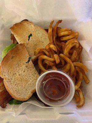 BLT served with seasoned curly fries