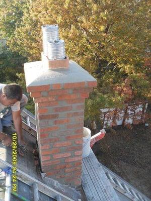 Re-pointing the mortar joints, resealing the chimney flashing, applying a new cement crown, and waterproofing the exterior ma...