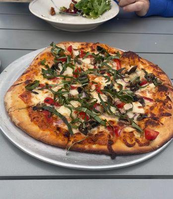 Tuscan Apple salad and pizza made with cherry tomato sauce and topped with chicken, mushrooms, onions, roasted red peppers and basil.