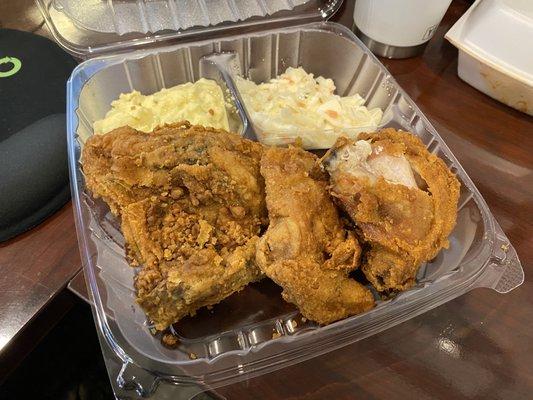 Fried chicken with potato salad and coke slaw is the perfect meal to go.