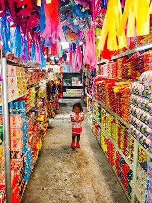 Inside one of the aisles of the store, almost floor to ceiling candies.